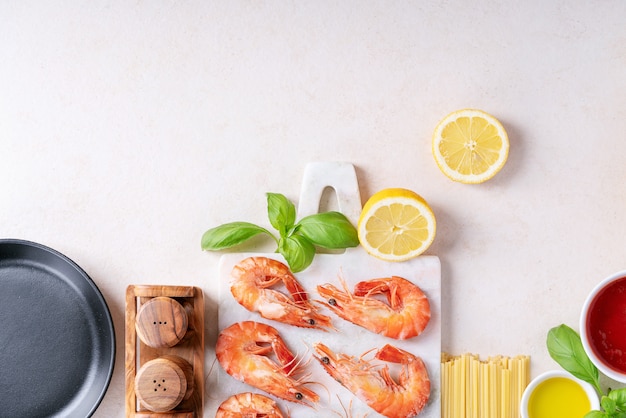 Raw ingredients for cooking: Shrimp prawns Italian spaghetti