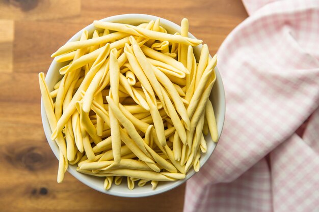 Raw italian pasta in bowl