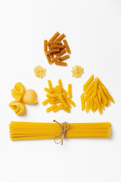 Foto spaghetti e pasta italiani crudi su un bianco