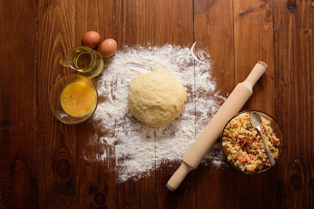 Raw kneaded dough on a wooden background