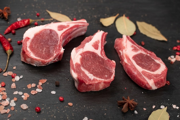 Raw lamb chops or mutton cuts with salt and spices. Fresh sheep ribs cutlet on bone closeup