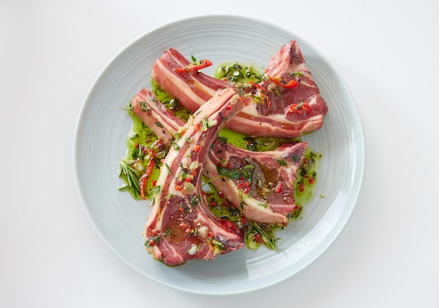 Raw lamb chops on plate