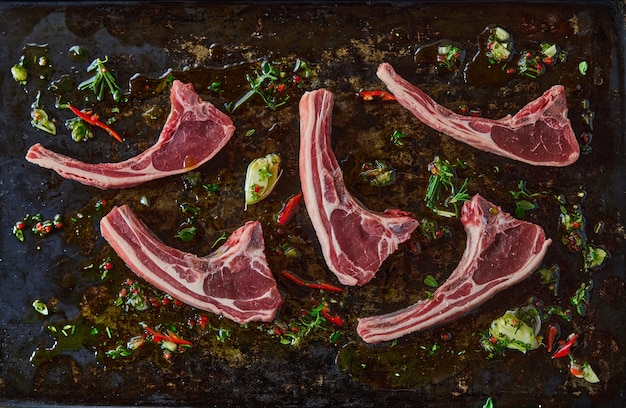 Raw lamb chops with greens