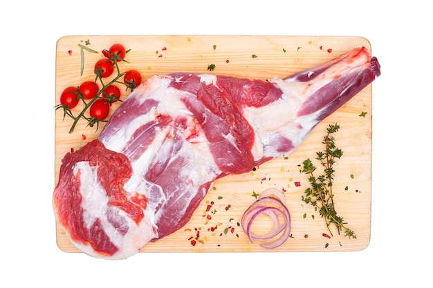 raw lamb leg, loin on bone with herbs, meat wooden cutting board, on a white isolated background