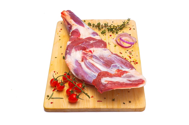 raw lamb leg, loin on bone with herbs, meat wooden cutting board, on a white isolated background