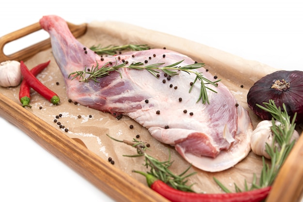 Raw lamb leg ready for cooking with garlic and rosemary