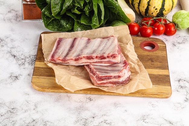 Raw lamb ribs for cooking over board