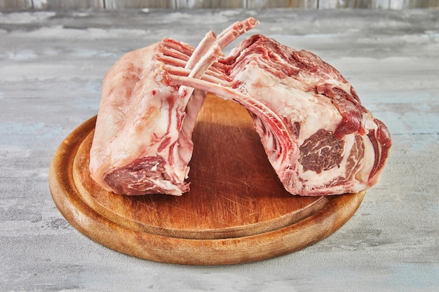 Raw lamb ribs on wooden board ready for cooking