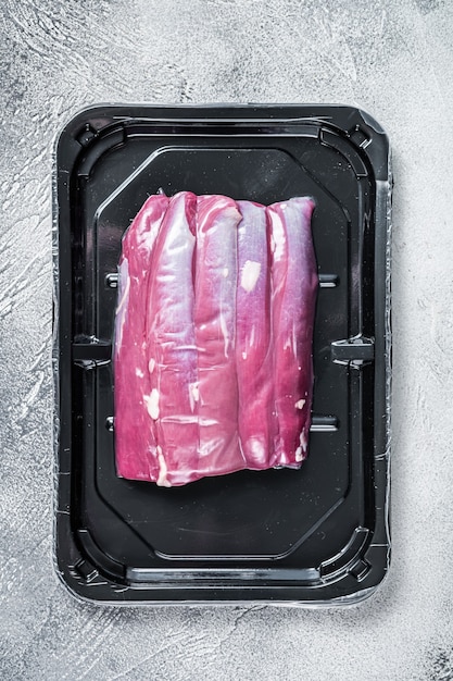 Raw lamb tenderloin in vacuum packaging.   Top view.