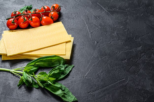 Raw lasagna sheets. Ingredients Basil, cherry tomatoes. 