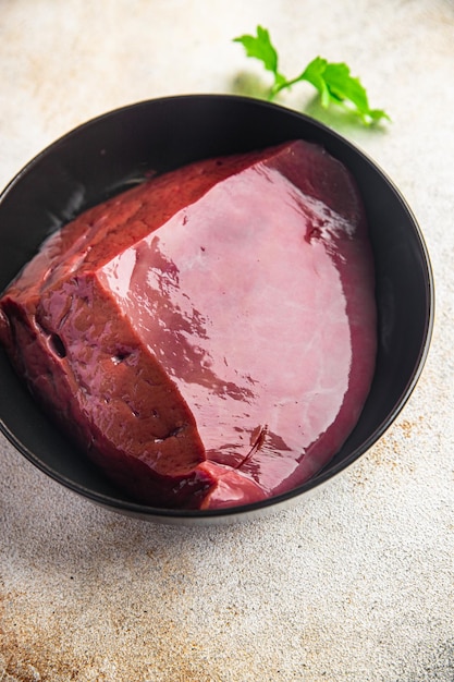 Raw liver beef or pork healthy meal food diet snack on the table copy space food background rustic