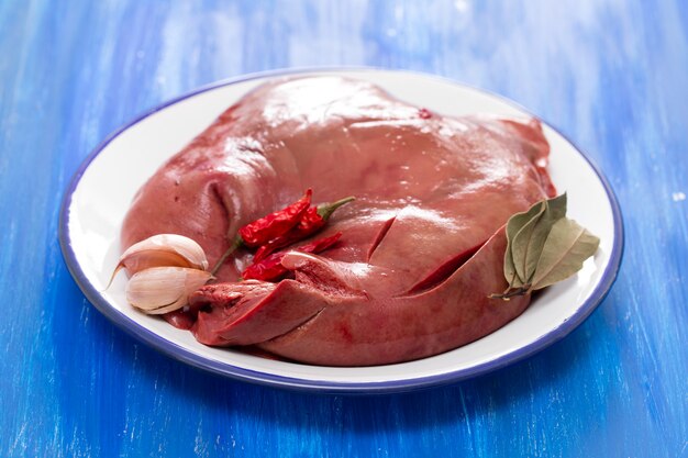 Raw liver of pork on white plate