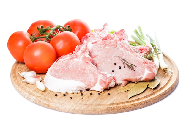 Raw loin slices on the board isolated on white