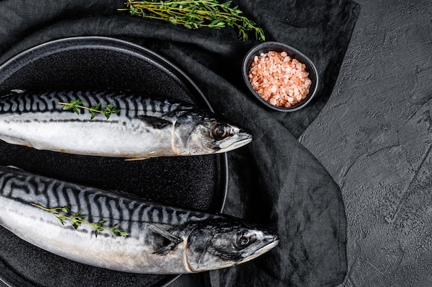 Raw mackerel fish with thyme and pink salt. Fresh seafood. Top view.