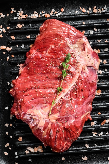 Raw marbled beef steak on a grill pan