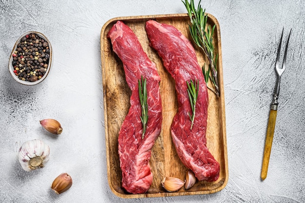 Raw marbled black angus beef meat steak. White background. Top view.