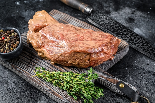 Raw marinated in mustard beef tri-tip steak for bbq.   Top view.