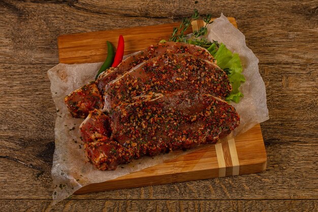 Raw marinated pork steak