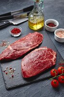 Raw meat beef steak on black top view