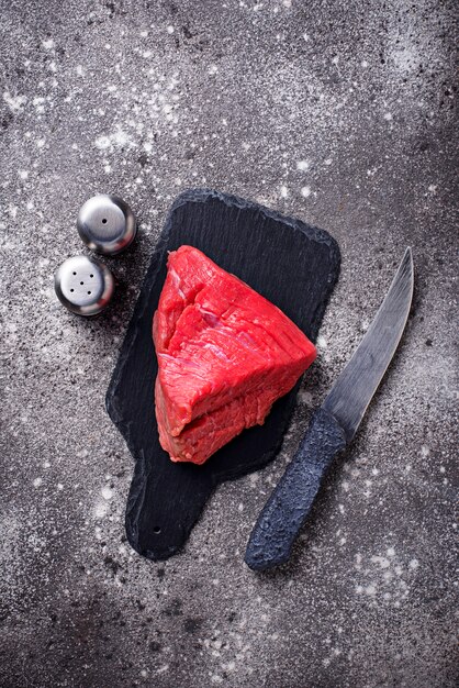 Raw meat on cutting board with spices 