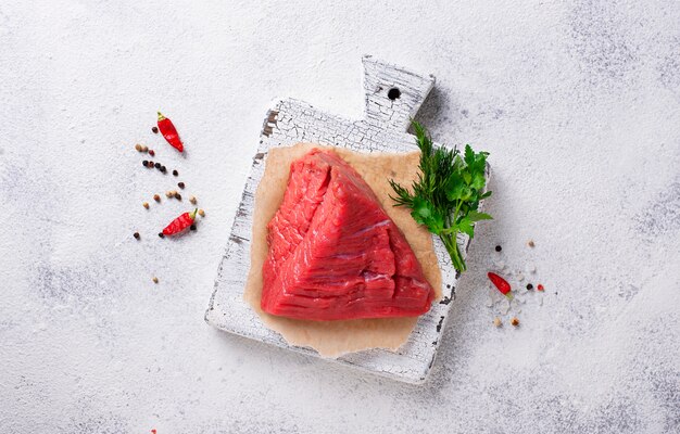 Raw meat on cutting board with spices 