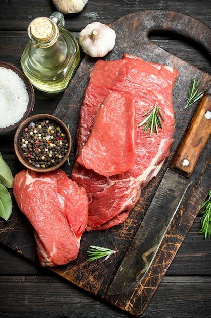 Raw meat Fresh beef with spices and an old knife