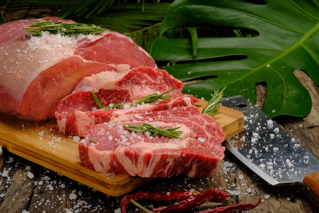 Raw meat fresh beef on wooden background Premium Photo