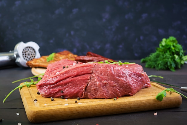 Raw meat. Fresh beef on wooden background