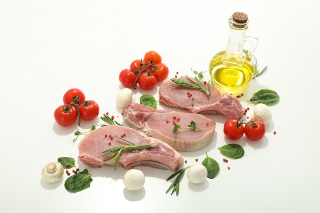 Raw meat and ingredients for cooking on white background