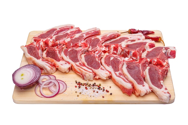 raw meat meat brisket beef on the bone on a wooden cutting board on a white isolated background