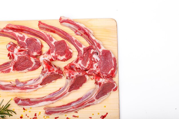 raw meat, meat brisket, beef on the bone, on a wooden cutting board, on a white isolated background,