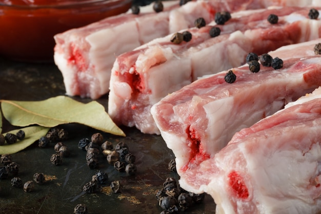 raw meat on rustic vintage table with spices