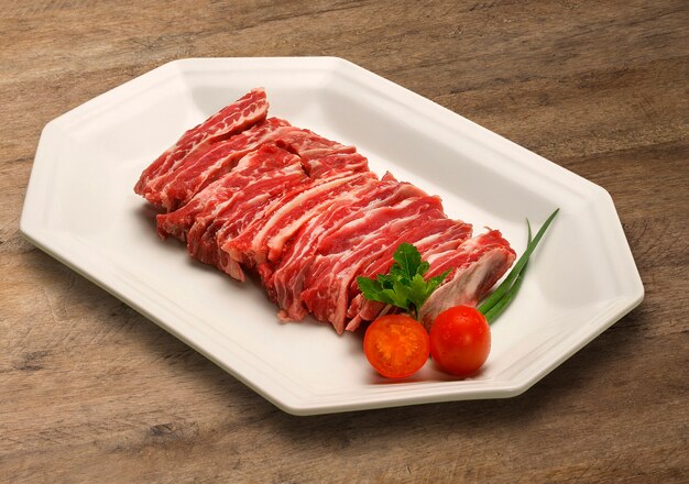 Raw meat selection on wooden cutting board.