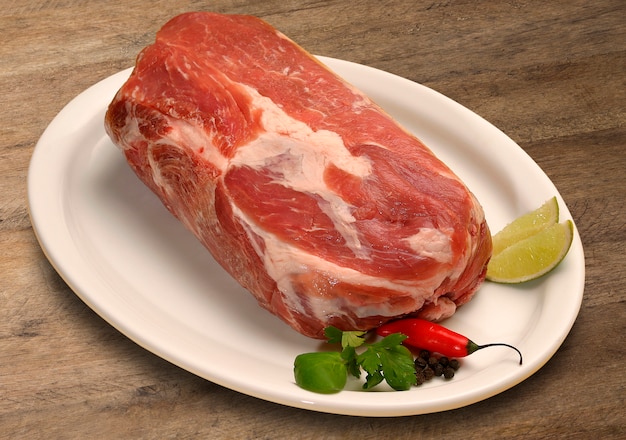 Raw meat selection on wooden cutting board.