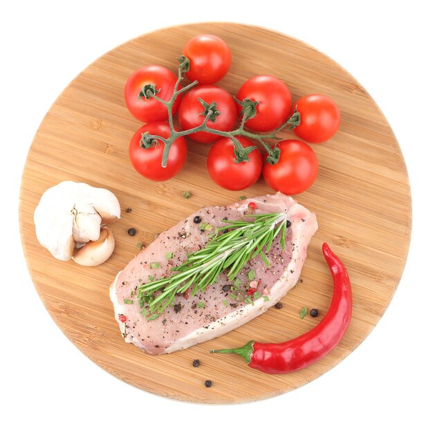 Raw meat steak with herbs and spices on cutting board isolated on white