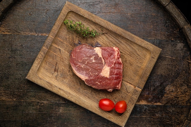 raw meat steak on a wooden board in a premium restaurant