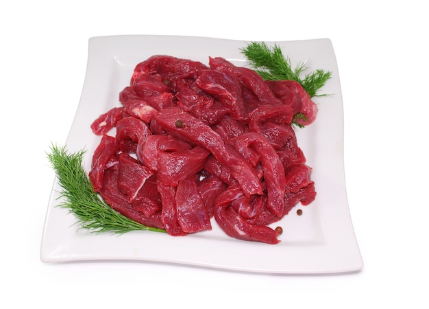 Raw Meat. Uncooked fresh beef slices isolated on white background