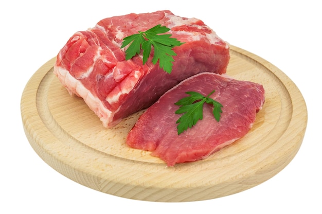 Raw meat with parsley on wooden plate isolated on white background