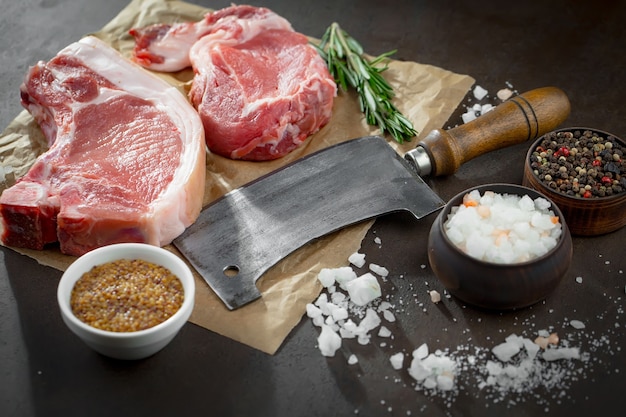 Raw meat with spices in a composition with kitchen accessories