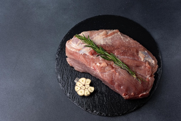 raw meat with spices on a dark background