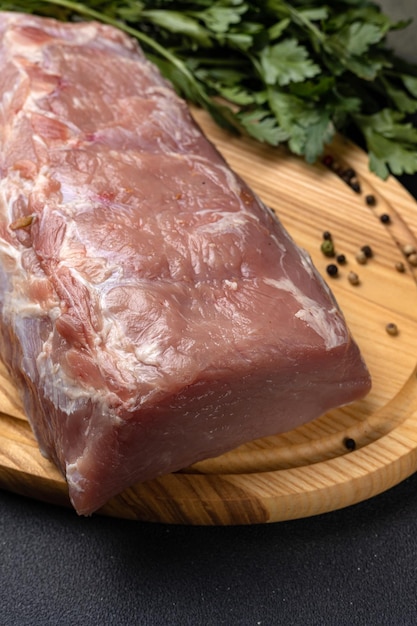 raw meat with spices on a wooden board