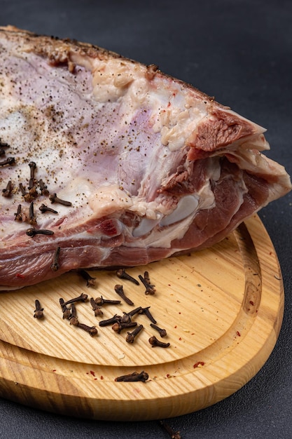 raw meat with spices on a wooden board