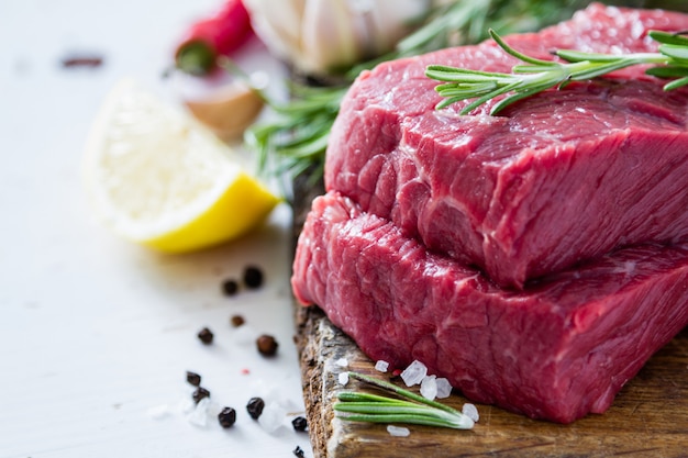 Raw meat on wood background