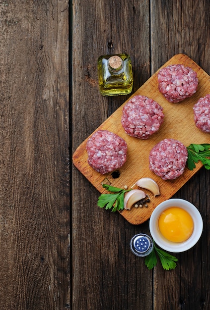 Raw meatballs on a chopping board