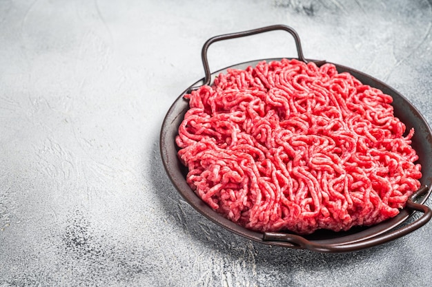 Raw Mince Ground meat in a kitchen tray White background Top view Copy space