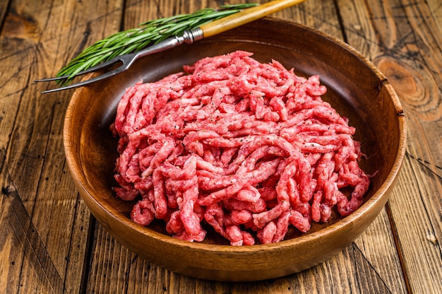 Raw mince lamb, ground mutton meat with herbs on a plate