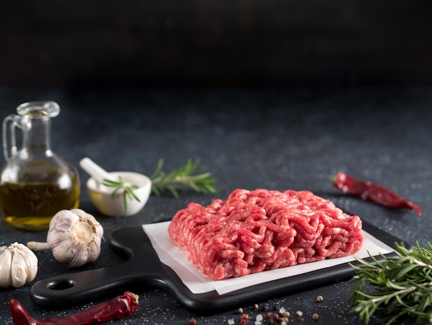 Raw minced beef on light gray cement background