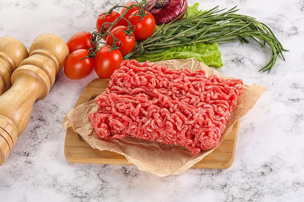 Raw minced beef meat on cutting board