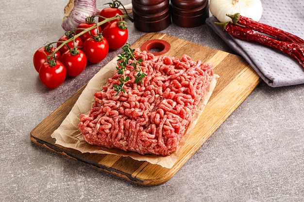 Raw minced beef uncooked meat over board