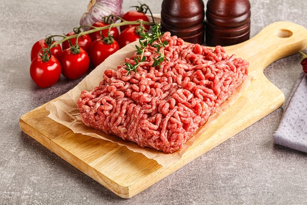 Raw minced beef uncooked meat over board